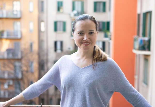 Olena poses on the balcony of the IRC Milan guesthouse.